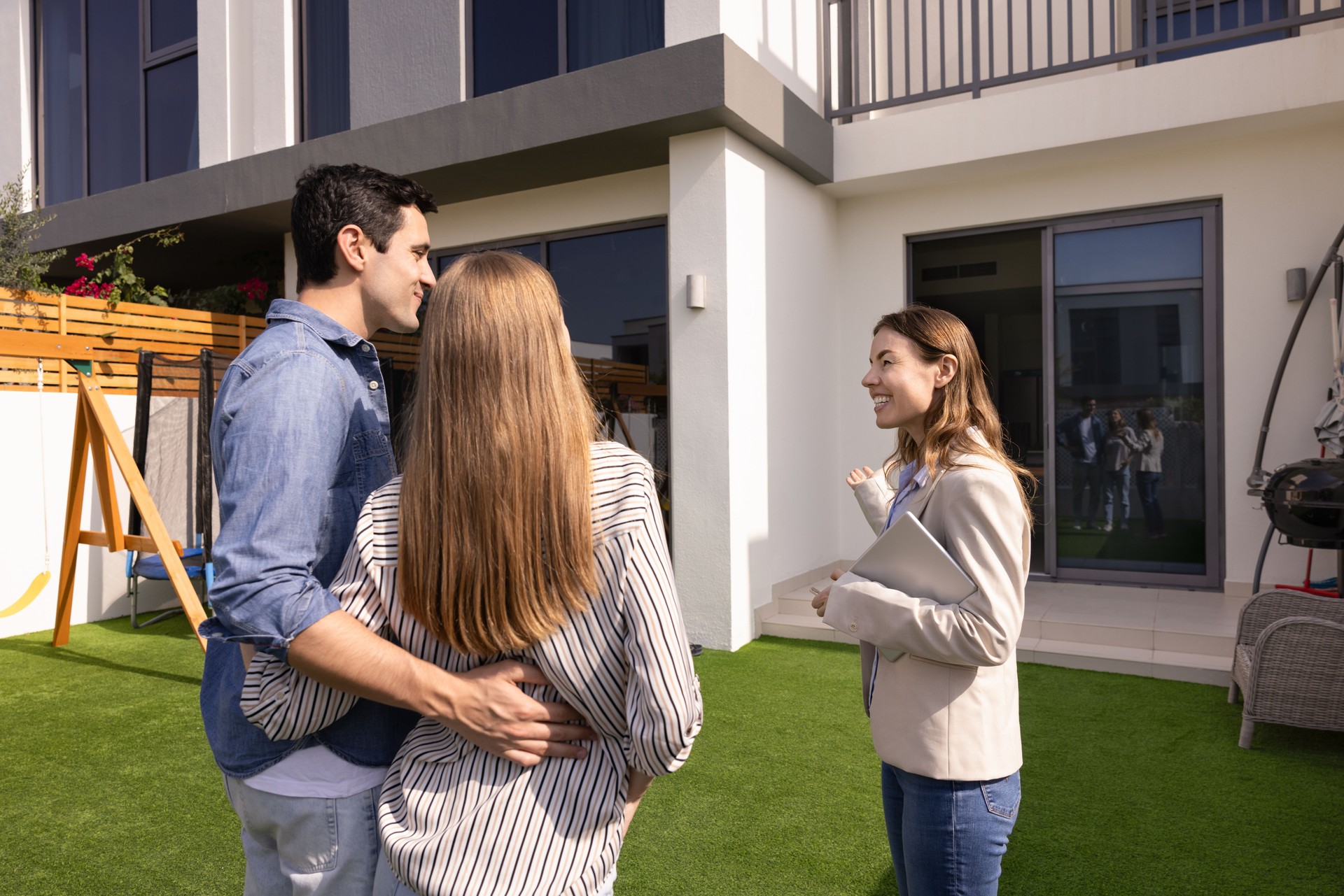Happy real estate agent woman showing house for sale